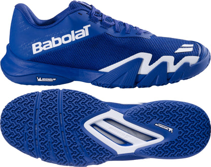 The Babolat Jet Viva Men's Padel Shoes in Marine Blue are displayed from the side and bottom, showcasing a textured Michelin rubber sole and white accents, with "Babolat" boldly printed in large white letters along the side. These lightweight padel shoes are designed to provide optimal comfort and durability on the court.