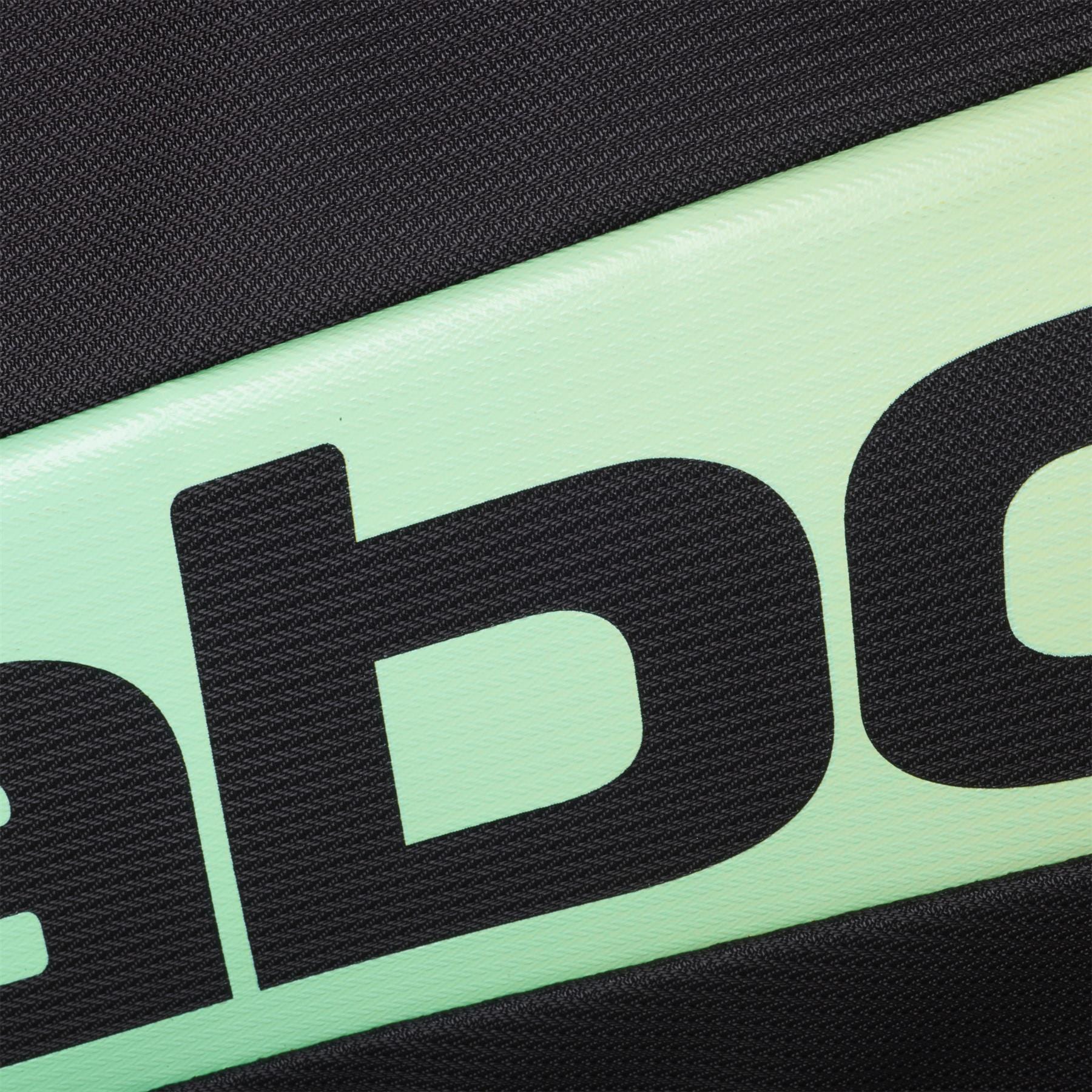 Close-up of the textured surface of the Babolat RH Pro 4 Racket Padel Bag (Black / Multi) by Babolat, showing part of large black text on a light green and black background, likely highlighting the insulated racket compartment. Partial letters visible.