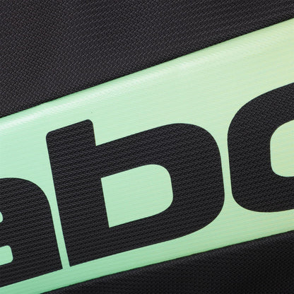 Close-up of the textured surface of the Babolat RH Pro 4 Racket Padel Bag (Black / Multi) by Babolat, showing part of large black text on a light green and black background, likely highlighting the insulated racket compartment. Partial letters visible.