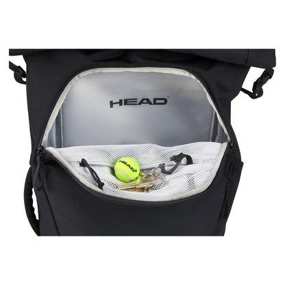 A black backpack, known as the HEAD Pro X Raqpack Padel Backpack, includes an open front pocket with a mesh compartment containing a tennis ball and keys. Inside, the lining showcases the "HEAD" brand name, highlighting its origins as the HEAD Pro X Raqpack. This eco-friendly backpack is also designed to hold various essentials.