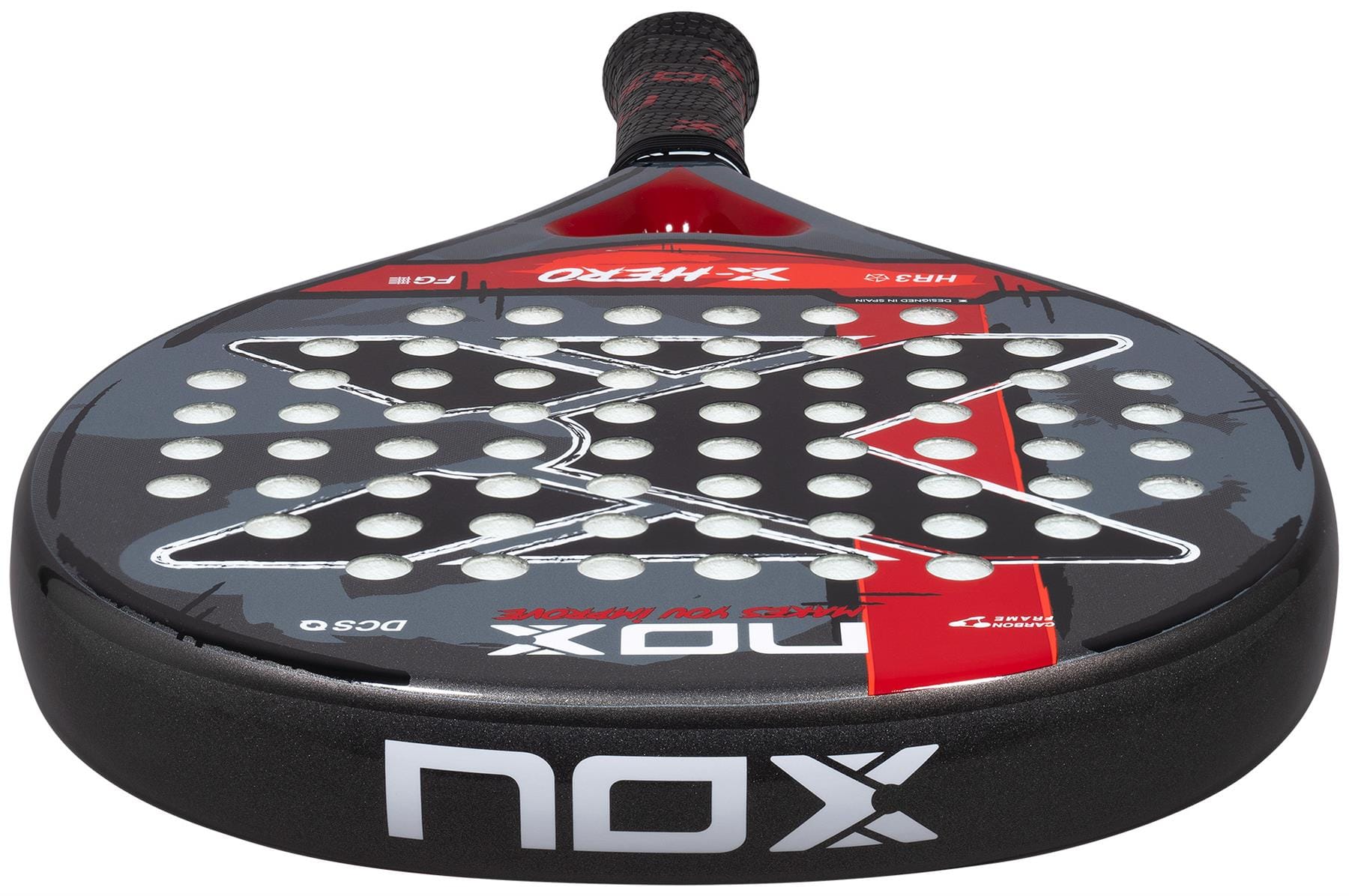 The NOX X-Hero Red Padel Racket, shown from a low front angle, features a black design with white circular holes, a red stripe accent, and bold “NOX” branding—ideal for beginners seeking control and precision.
