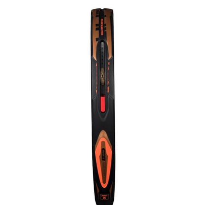 A close-up of a black and orange ski with detailed markings and central binding, inspired by the intelligent balance system of top gear like the adidas Arrow Hit CTRL 2026 Padel Racket.