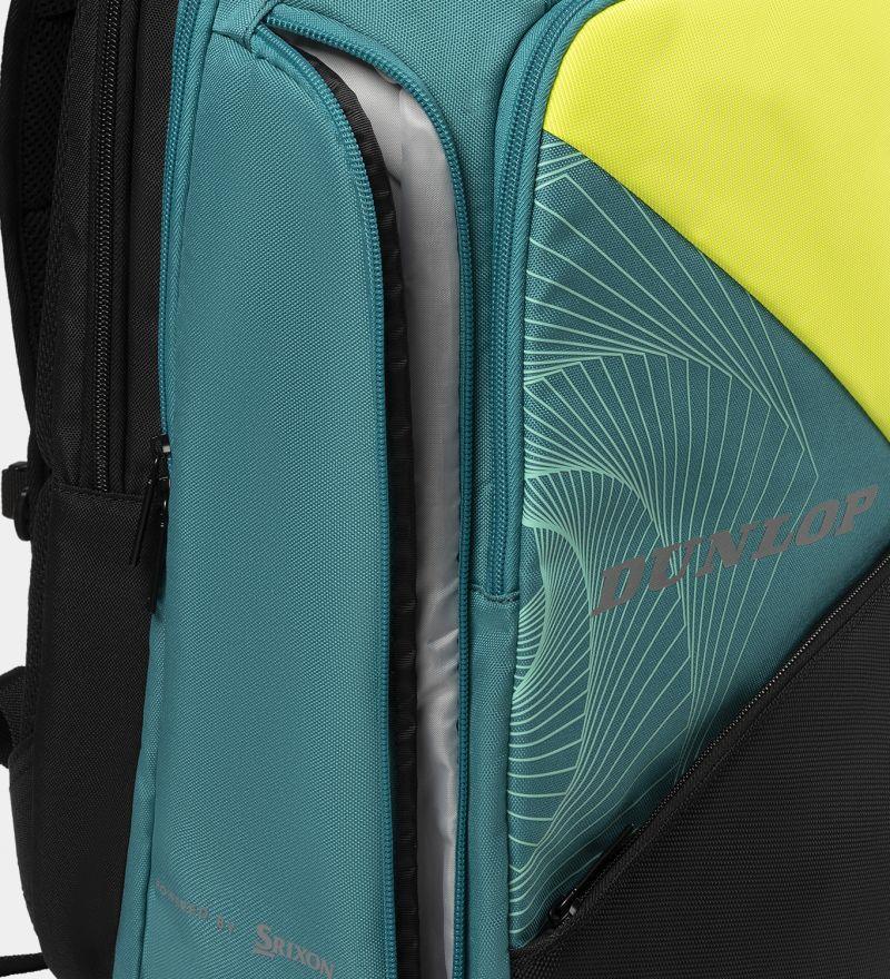 A close-up of the vibrant Dunlop SX Performance Padel Backpack in black, teal, and yellow geometric designs prominently displays the "Dunlop" brand on the front. Ideal for serious players, it includes multiple compartments with partially opened zippers.