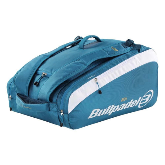 The Bullpadel BPP26021 Pearl Padel Bag in blue features white accents, multiple zippered compartments, and carrying handles, perfect for sports equipment from the Bea González Pearl range.