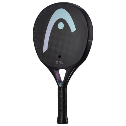 The HEAD One Ultralight Padel Racket - Black is a black and gray paddle that boasts a gradient design on its face, with the word "One" displayed beneath the logo. Incorporating auxetic technology, this ultralight racket not only enhances performance but also offers a sleek, modern aesthetic. The handle is wrapped in black grip tape to provide a striking contrast.