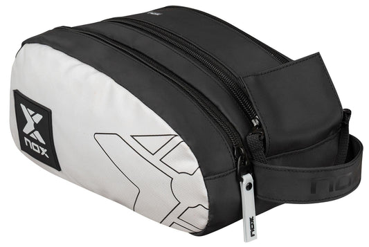 The NOX Luxury Travel Kit Bag - Black/Grey by NOX features a zippered closure, handle, geometric design, and logo—ideal as a padel bag or for organizing toiletries and accessories.