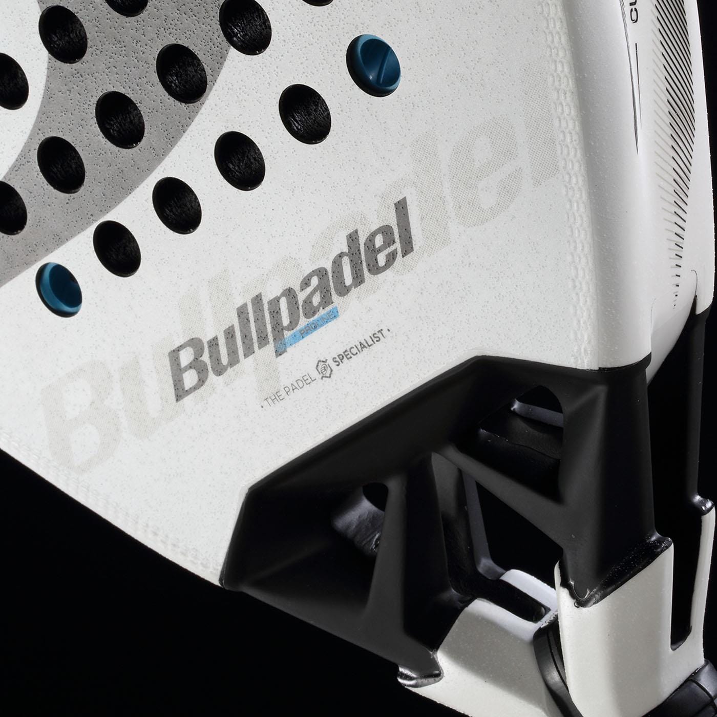Close-up of the Bullpadel Vertex 05 2026 Padel Racket in white and black, showcasing the Bullpadel logo, textured finish, perforated surface, and black handle set against a black background.