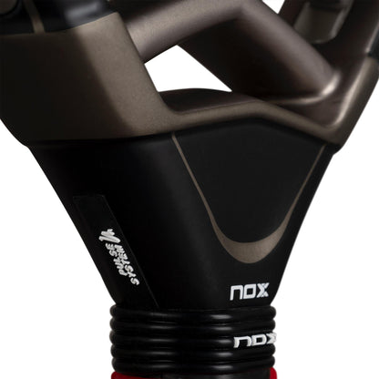 Close-up of the NOX AT10 Pro Cup Hard By Agustín Tapia 2026 Padel Racket by NOX, highlighting the handle, frame, and logo in bold black, grey, and red.