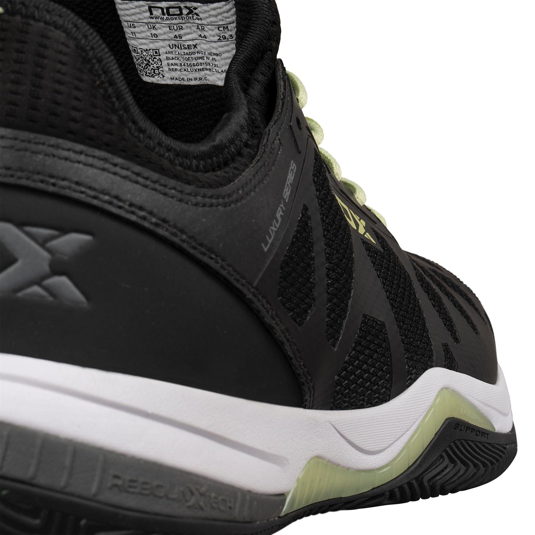 Close-up of the heel and side of NOX Nerbo Men's Padel Shoes by NOX in black/soft lime, showing mesh and synthetic materials for breathability, white and soft lime sole details for support, plus part of the shoe label inside the collar.