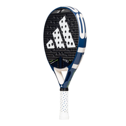 The ADIDAS Cross It Carbon CTRL Padel Racket by adidas features a sleek black and blue design with white trim and a prominent logo on its perforated Carbon 6K surface. Its white handle, adorned with blue dots, ensures control and precision with every swing.