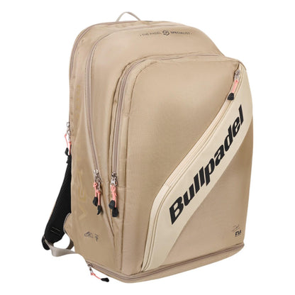 The Bullpadel Vertex 25 Padel Backpack in stone features multiple compartments, black zippers, and a reinforced thermo-lined section. The brand name is prominently displayed diagonally across the front in black letters, making it perfect for stylishly carrying your Vertex Padel Racket and essentials.