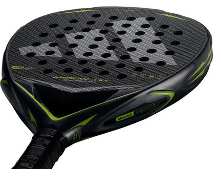 Close-up view of the adidas Arrow Hit Carbon 2026 Padel Racket, showcasing its black and green carbon surface, circular holes, textured detailing, and distinct adidas branding on the edge and handle.