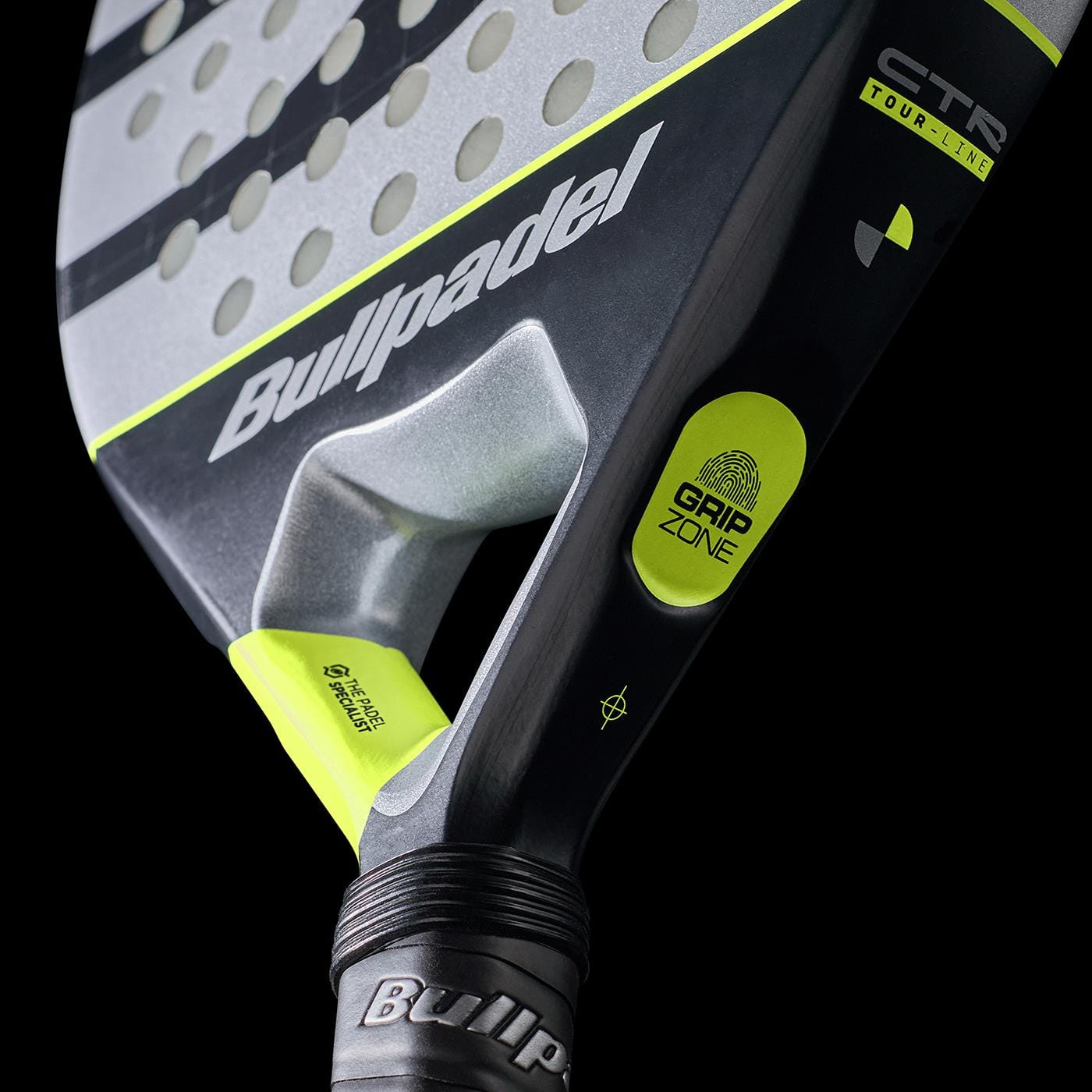 Close-up of the Bullpadel Indiga Ctr 2026 Padel Racket featuring the Bullpadel logo, perforated face, Grip Zone label, and yellow accents on a black background for precision control.