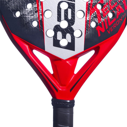 Close-up of the red and black Babolat Technical Veron 3.0 Padel Racket, showcasing its CarbonFlex construction, signature Babolat logo, perforated face, and part of the black grip handle.