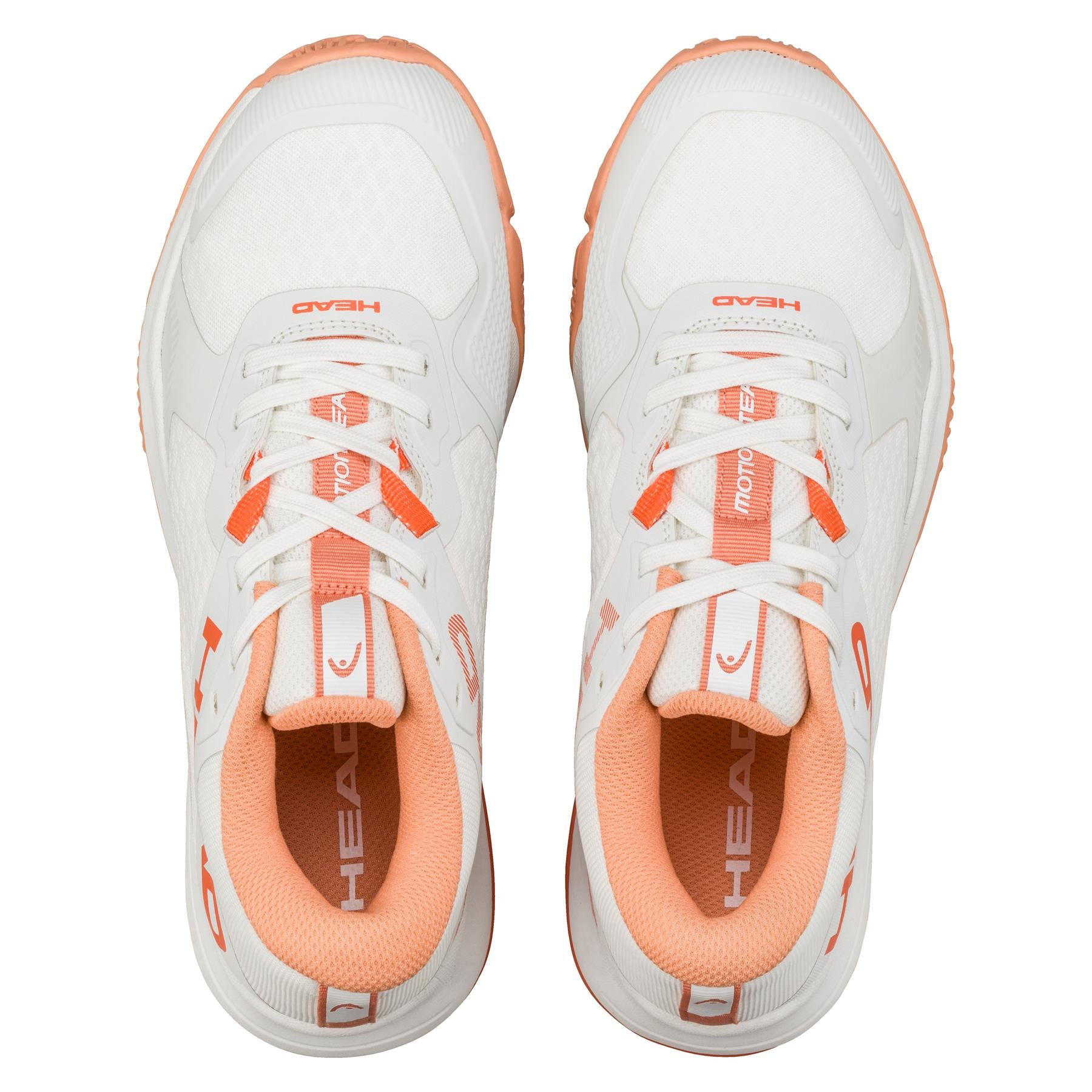 Aerial shot of HEAD Motion Team Women's Padel Shoes in white/coral, showing brand name on the tongue. Designed for stability and comfort, they boast a textured look with coral accents and multi-directional grip soles. Both shoes are displayed side by side.
