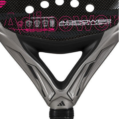 The ADIDAS Adipower Carbon Light 3.4 Padel Racket in silver and pink features a sleek design with Carbon 3K Fibre texture. "Adipower" branding stands out in bold pink, highlighting structural reinforcement, a 3D Spin Blade Mold, and a gracefully positioned handle at the bottom.