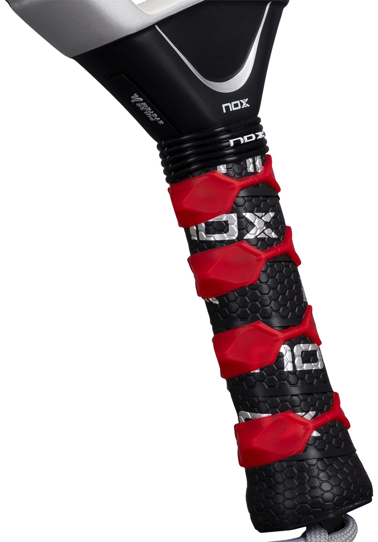 Close-up of the NOX Luxury AT10 Genius Attack 18K Alum By Agustin Tapia 2026 padel racket handle, with a black and red textured grip, honeycomb pattern, and elegant red accents highlighting its premium carbon build.