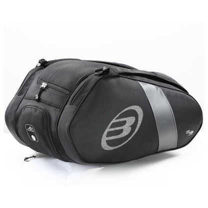 The Bullpadel Neuron 25 Padel Racket Bag is a black motorcycle tail bag with silver accents and a logo on the side, featuring multiple zippered compartments and an aerodynamic design, set against a plain white background.