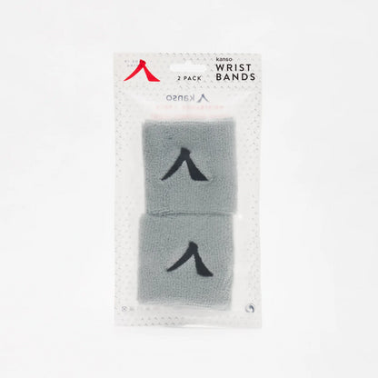 The Kanso 7cm Wristband 2 Pack - Grey includes two bands with a subtle black logo. Crafted from absorbent fabric for optimal comfort, they come in clear packaging showcasing the Kanso branding at the top.