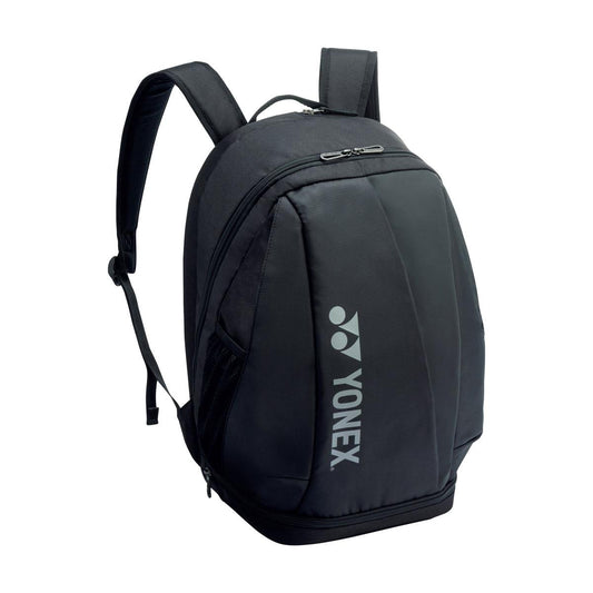 The stylish Yonex 92412MEX Pro Padel Backpack in black prominently displays the renowned Yonex logo in white on the front. It includes padded shoulder straps, various zipped compartments, a dedicated space for racket storage, and a separate compartment for shoes to ensure maximum convenience.