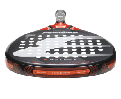 A close-up of the Bullpadel Vertex Junior 25 Padel Racket in black, ideal for young players. It features numerous round holes, "Bullpadel," and "Vertex 3.1" branding, emphasizing balance, with a grey grip-wrapped handle.