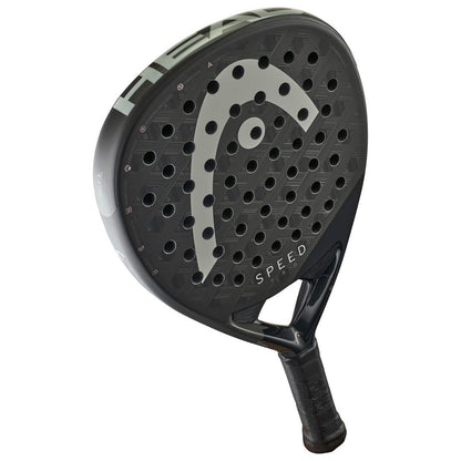 The HEAD Speed Pro 2025 Padel Racket in black showcases a distinct logo on its face with circular holes for improved aerodynamics. Featuring Damp Plus tech, "Speed" is printed near the grip handle.