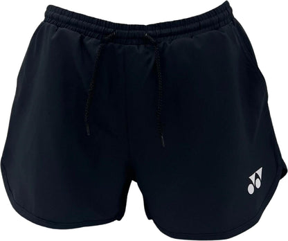The Yonex YST2024 Womens Padel Shorts in black feature breathable sports fabric, an elastic waistband, black drawstrings, and a small white logo on the lower left leg for lightweight comfort during active days.