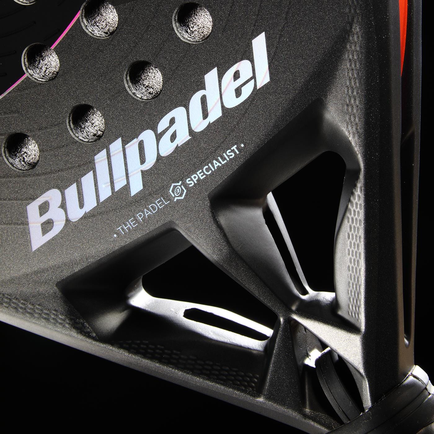 Close-up of the Bullpadel HACK 04 Comfort 2026 Padel Racket - Grey, showing the Bullpadel logo, textured black surface with circular holes, and angular frame design for dynamic power on court.