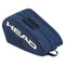 The HEAD Base Padel Racket Bag M in navy includes dual top zippers, accessory pockets, and a side handle. It has reinforced construction for durability with "HEAD" printed in large white letters on the side.