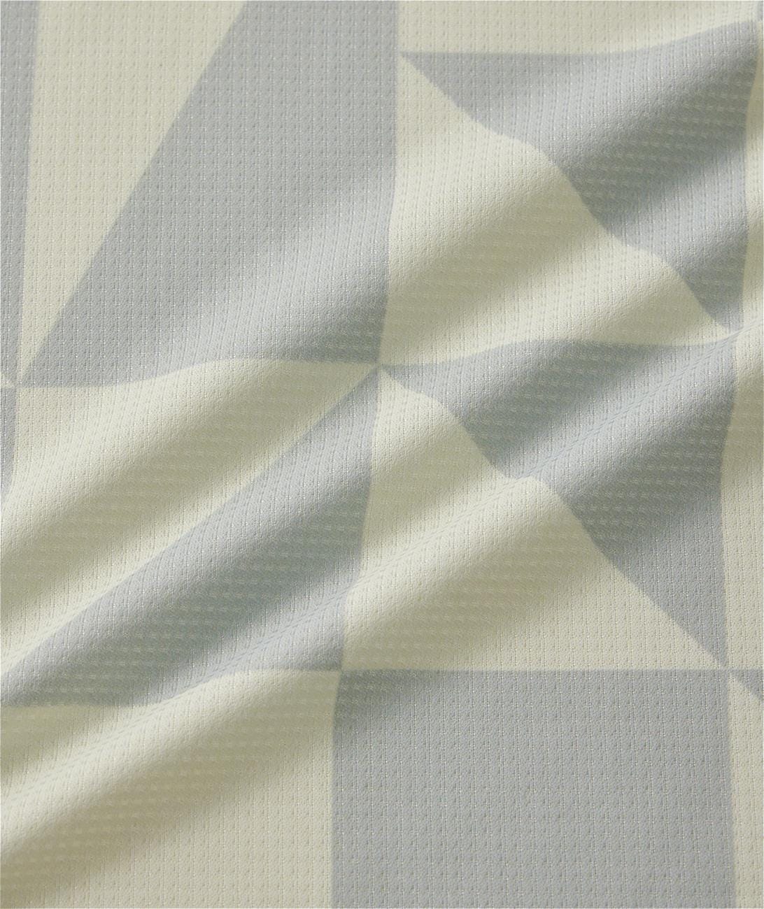 A close-up of the Yonex 10712YX Crew Neck Men's Padel T-Shirt in champagne, showing its textured geometric fabric with light beige and pale gray tones, creases, and soft folds typical of quick-drying Yonex sportswear.