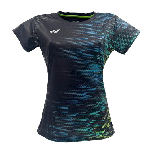 The Yonex YTL7 Women's Padel T-Shirt - Shadow is a tailored-fit, short-sleeve athletic top with a dark base and pixelated blue and green pattern. Made from moisture-wicking polyester, it features the Yonex logo on the upper left chest.