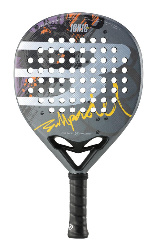 The Bullpadel Ionic Control 2024 Padel Racket features a modern grey design with perforated holes and a signature motif highlighted in yellow and white. Its abstract patterns in purple, orange, and dark gray are artfully integrated into the carbon fiber structure, complemented by its black grip handle for superior performance.