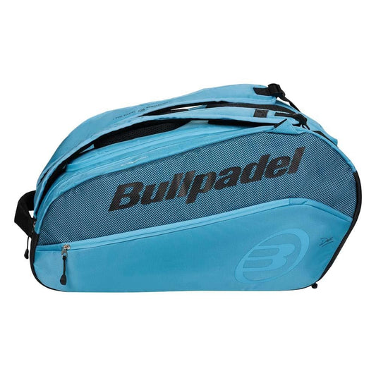 The Bullpadel BPP26003 Vertex W Padel Bag in light blue features zippered compartments, black mesh accents, and the Bullpadel logo—ideal for carrying all your padel gear.