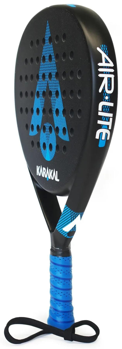 The Karakal Air Lite 345 Blue Padel Racket by Karakal stands upright on its edge, featuring a lightweight black and blue design with a perforated surface, blue grip, and wrist strap.