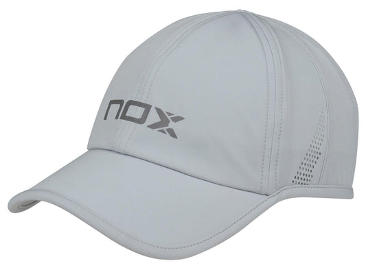 The NOX Padel Cap - Grey is a lightweight, breathable cap with "NOX" in bold letters on the front, side ventilation holes, and an adjustable velcro strap for comfort.