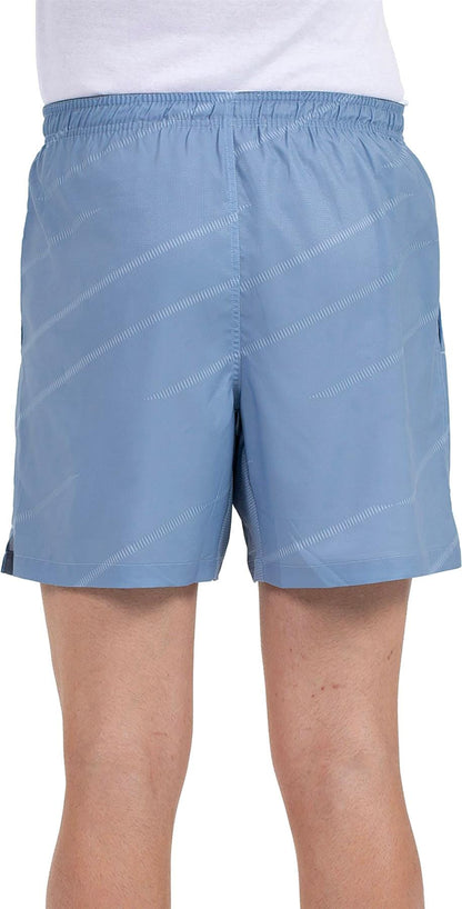 A person wears Bullpadel Cabanas Mens Padel Shorts in shadow blue, featuring a subtle diagonal stripe, elastic waistband, and Quickerdry tech for comfort and dryness—perfect for enhancing padel court performance.