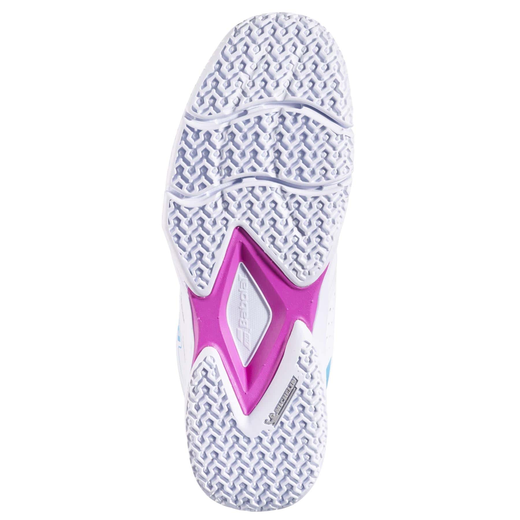 The image shows the sole of the Babolat Sensa Rise Womens Padel Shoe in White/Rhodamine Red, featuring a white Michelin rubber grip, purple and gray midsection, "Babolat" branding, and zigzag plus herringbone tread for padel.