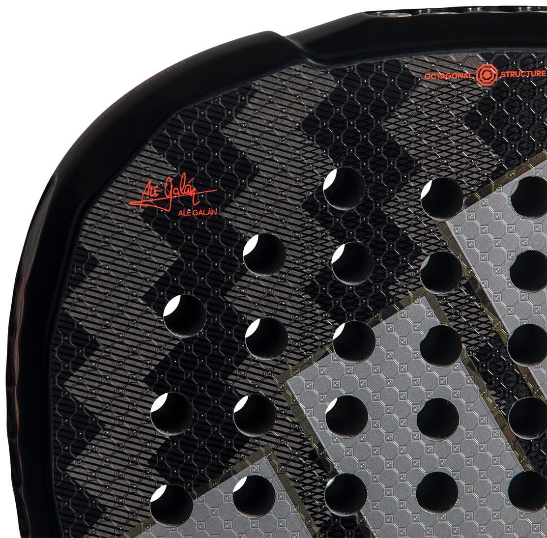 Close-up of the adidas ADIDAS Metalbone by Ale Galán 2026 Padel Racket in black, showing textured gray design, circular holes, red signature, geometric patterns, and an innovative adjustable weight system.