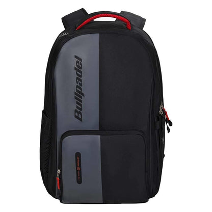The Bullpadel BPM26020 Neuron Padel Backpack - Black, used by Fede Chingotto, sports a black and gray design with a red handle, dual zippered front pockets, mesh side pocket, and the Bullpadel logo vertically on the front.