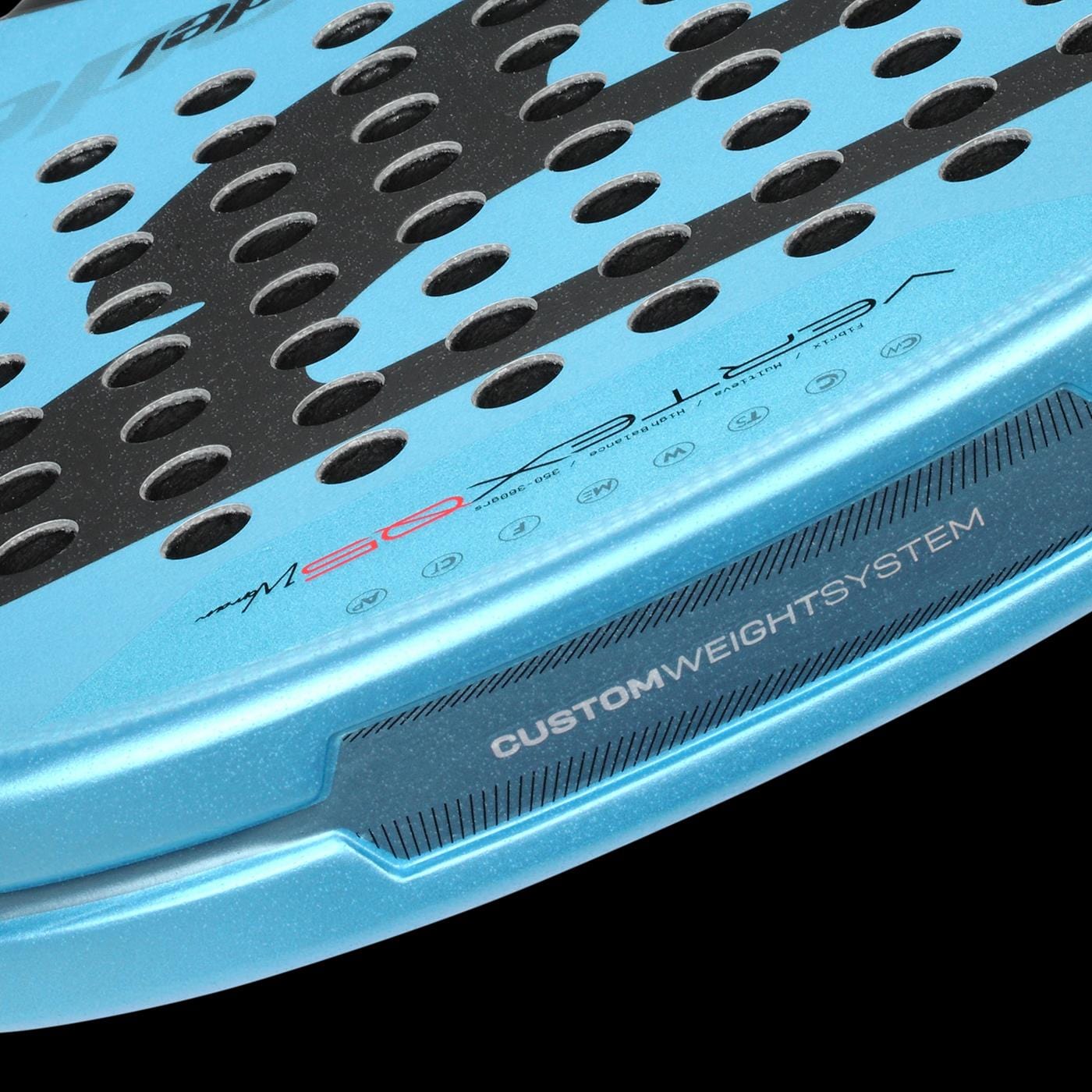 Close-up of the Bullpadel Vertex 05 W 2026 Padel Racket in Black/Blue, featuring multiple circular holes and "CUSTOM WEIGHT SYSTEM" on the frame, similar to Dolph Brea’s racket.