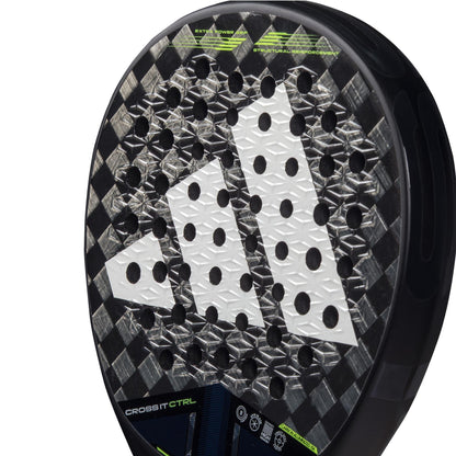 Close-up of an ADIDAS Cross It CTRL 3.4 padel racket in black and grey, showcasing a checkered design with a large white logo at the center. This racket is for advanced players seeking control, featuring Carbon 15K technology and "CROSSBIT CTRL" elements on its surface.