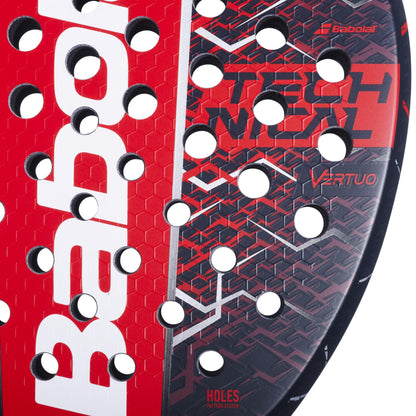 Close-up of the Babolat Technical Vertuo 2.5 Padel Racket in red and black, featuring a honeycomb pattern with circular holes and "Technical Vertuo" on the surface—engineered by Babolat for comfort and powerful, easy play.