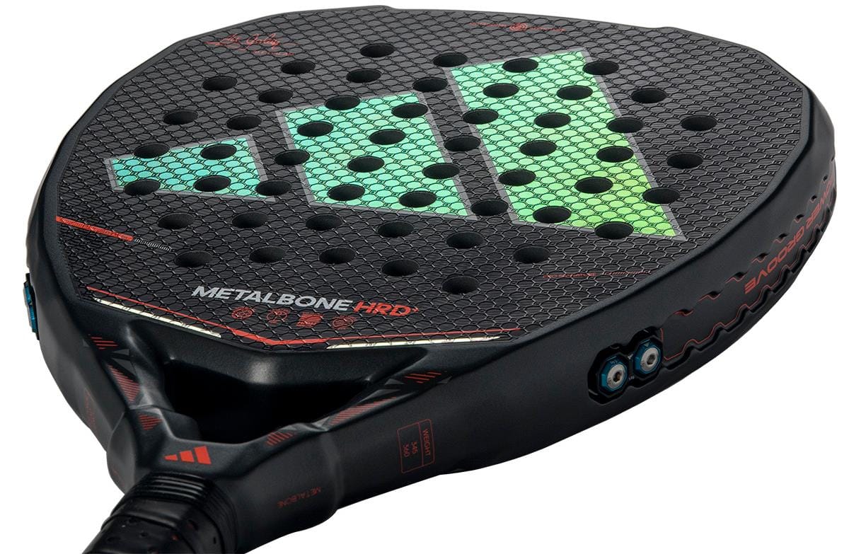 Close-up of the adidas Metalbone HRD+ by Ale Galán 2026 padel racket in black/red, featuring a honeycomb pattern, green geometric design, red accents, "METALBONE HRD" text, and adjustment screws for elite power performance.