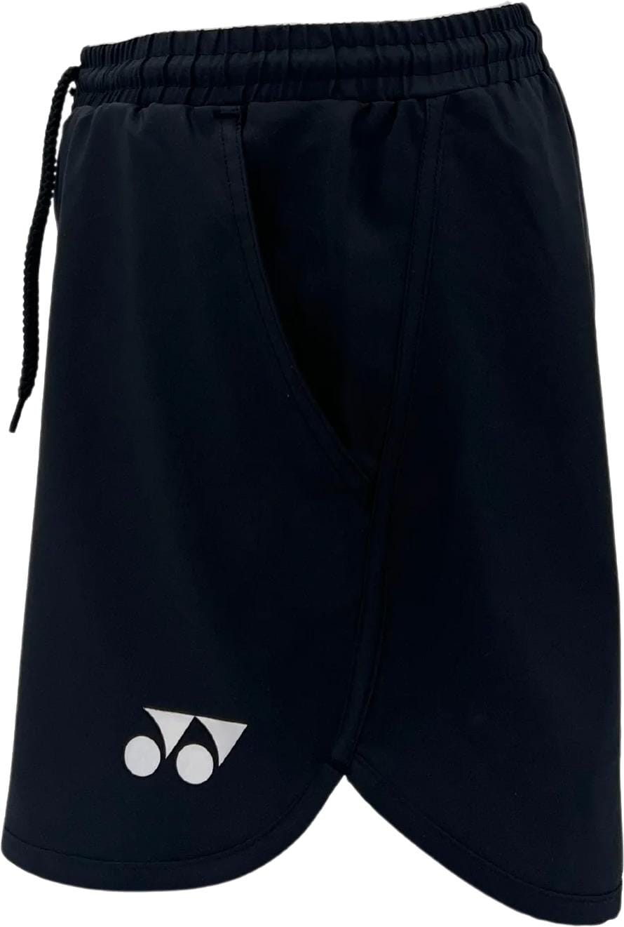 The Yonex YST2024 Womens Padel Shorts in black feature a white Yonex logo near the bottom left hem, breathable sports fabric, an elastic waistband with drawstring, and a visible side pocket.