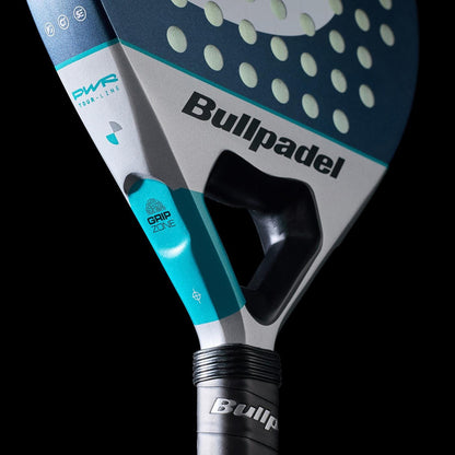 Close-up of the Bullpadel Indiga Pwr 2026 Padel Racket, highlighting its Bullpadel branding, grip zone label, and perforated hitting surface against a black background.