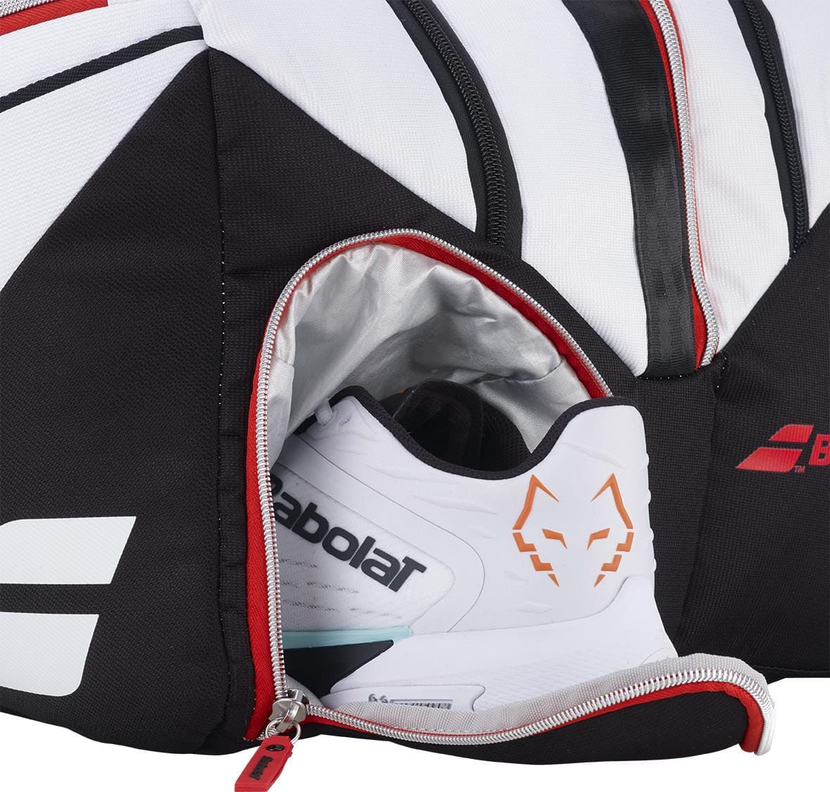 A close-up of the Babolat RH Pro Technical Padel Racket Bag in white, black, and red with a partially open zippered compartment revealing a Babolat athletic shoe—ideal for keeping your padel accessories organized.