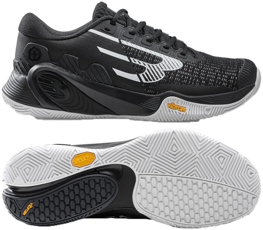 The Bullpadel Vertex Vibram 26V Men's Padel Shoes in black feature a white geometric pattern and a textured black-and-white Vibram outsole for grip, shown in side and bottom views—ideal high-performance footwear from Bullpadel.