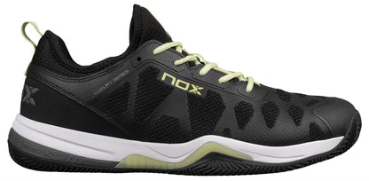 The NOX Nerbo Men's Padel Shoes in black/soft lime feature light green laces, a white midsole, black outsole, “NOX” branding, a textured design, Ortholite insole for comfort, and reinforced heel and toe caps for durability.