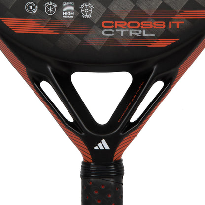 Close-up of the adidas Cross It CTRL Padel Racket - Black / Red, adorned with the words "Cross It CTRL." The design showcases geometric patterns and logos, equipped with a Spin Blade Mold for improved control and spin, emphasizing the handle area.