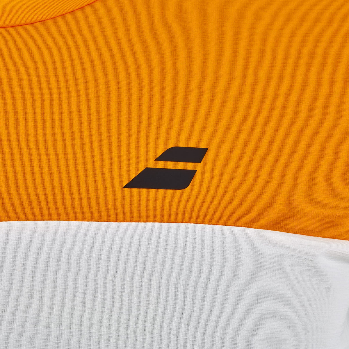 Close-up of the Babolat Crew Neck Mens Padel T-Shirt in Orange / Cream, featuring an orange upper section, a cream lower section, and a small black geometric logo with two angled bars on the chest—a stylish example of premium padel clothing by Babolat.